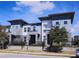 Charming townhomes with a contemporary design, featuring a mix of blue and white siding with black accents at 7381 Alpine Butterfly Ln, Orlando, FL 32819