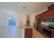 Open-concept kitchen with granite countertops, stainless steel appliances, and a large island at 7381 Alpine Butterfly Ln, Orlando, FL 32819