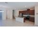 Open-concept kitchen with granite countertops, stainless steel appliances, and a large island at 7381 Alpine Butterfly Ln, Orlando, FL 32819