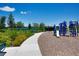 Playground equipment next to a winding sidewalk and benches with lake view at 7381 Alpine Butterfly Ln, Orlando, FL 32819