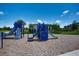Blue playground equipment including slides, stairs, and a rope bridge at 7381 Alpine Butterfly Ln, Orlando, FL 32819