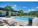 Community pool area with lounge chairs and shady seating areas at 7381 Alpine Butterfly Ln, Orlando, FL 32819
