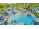 Aerial view of the zero-entry community pool and splashpad with lounge seating and shade at 7973 Greengard St, Orlando, FL 32827