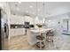 Modern kitchen featuring white cabinetry, granite counters, and a kitchen island with seating at 7973 Greengard St, Orlando, FL 32827