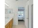 Bright bathroom featuring double sinks with wood cabinets and an open doorway leading into a bedroom at 8595 Sunrise Key Dr, Kissimmee, FL 34747