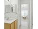 Bathroom featuring a single sink vanity and a doorway that leads into a beautifully decorated bedroom at 8595 Sunrise Key Dr, Kissimmee, FL 34747