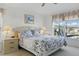 Comfortable bedroom with a queen bed, bedside tables, and a window overlooking the backyard at 8595 Sunrise Key Dr, Kissimmee, FL 34747