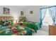 Bright bedroom featuring twin beds with cartoon-themed bedding and a window with blue curtains at 8595 Sunrise Key Dr, Kissimmee, FL 34747