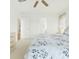 Bedroom features a light-colored bed, ceiling fan, and a large window at 8595 Sunrise Key Dr, Kissimmee, FL 34747