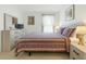 Comfortable bedroom featuring warm, neutral colors and a window that provides ample natural light at 8595 Sunrise Key Dr, Kissimmee, FL 34747