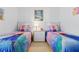 Charming bedroom featuring two twin beds with Frozen-themed bedding and bright decor at 8595 Sunrise Key Dr, Kissimmee, FL 34747