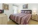 Comfortable bedroom featuring warm, neutral colors, two nightstands and a view out the window at 8595 Sunrise Key Dr, Kissimmee, FL 34747
