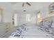 Bright bedroom with neutral color scheme, ceiling fan, and en-suite bathroom access at 8595 Sunrise Key Dr, Kissimmee, FL 34747