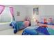 Charming bedroom with two twin beds, Frozen themed bedding, creating a playful and inviting space at 8595 Sunrise Key Dr, Kissimmee, FL 34747
