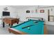 Spacious game room equipped with a pool table, foosball, and air hockey at 8595 Sunrise Key Dr, Kissimmee, FL 34747