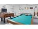 Spacious game room with a pool table, foosball, air hockey and laundry area for ultimate entertainment at 8595 Sunrise Key Dr, Kissimmee, FL 34747