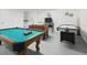 Spacious game room with a pool table, foosball, air hockey, and laundry appliances at 8595 Sunrise Key Dr, Kissimmee, FL 34747