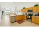 Bright kitchen featuring stainless steel appliances, wooden cabinets, and an adjacent dining area at 8595 Sunrise Key Dr, Kissimmee, FL 34747
