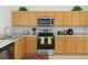 Well-lit kitchen featuring light wood cabinets, stainless steel appliances, and ample counter space at 8595 Sunrise Key Dr, Kissimmee, FL 34747
