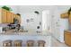Practical kitchen featuring a breakfast bar, wood cabinets, tile flooring, and modern appliances at 8595 Sunrise Key Dr, Kissimmee, FL 34747