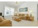 Bright living room with large windows, neutral tones, comfortable seating, and warm carpeting at 8595 Sunrise Key Dr, Kissimmee, FL 34747