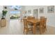 Open-concept dining and living area with tile flooring and sliding glass doors to the backyard at 8595 Sunrise Key Dr, Kissimmee, FL 34747