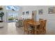 Inviting living room with tile flooring, dining area, and sliding glass doors to the pool at 8595 Sunrise Key Dr, Kissimmee, FL 34747