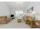 Bright living room with comfortable seating, neutral carpeting and natural light, creating a warm, inviting space at 8595 Sunrise Key Dr, Kissimmee, FL 34747