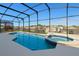 Screened-in pool and spa with an expansive deck surrounded by neighborhood views at 8595 Sunrise Key Dr, Kissimmee, FL 34747