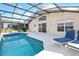 Enjoy this beautiful screened-in pool with an attached lanai, lounge chairs, and outdoor seating area at 8595 Sunrise Key Dr, Kissimmee, FL 34747