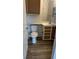Cozy bathroom featuring vinyl flooring, toilet, and vanity with ample lighting at 8927 Legacy Ct # 302, Kissimmee, FL 34747