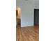 View of bedroom with wood floors leading to the ensuite bath and closet at 8927 Legacy Ct # 302, Kissimmee, FL 34747