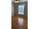 Comfortable bedroom featuring wood floors, ceiling fan, and natural light at 8927 Legacy Ct # 302, Kissimmee, FL 34747
