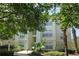 Condominium building featuring lush landscaping, multiple levels and well maintained common areas at 8927 Legacy Ct # 302, Kissimmee, FL 34747