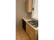 Kitchen featuring double stainless steel sink, tan cabinets, and laminate countertop at 8927 Legacy Ct # 302, Kissimmee, FL 34747