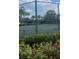 Community tennis court with net and fencing surrounded by well maintained landscaping at 8927 Legacy Ct # 302, Kissimmee, FL 34747