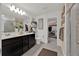 Bathroom with double sink vanity, walk in shower, and closet access at 1562 Delightful Dr, Davenport, FL 33896
