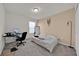 Neutral bedroom with a plush bed, ample natural light, and space for a home office at 1562 Delightful Dr, Davenport, FL 33896