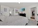 Neutral bedroom with a tv, carpet flooring, and three access doors at 1562 Delightful Dr, Davenport, FL 33896