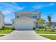 Charming two-story home with attached two-car garage, landscaped yard, and freshly painted exterior at 1562 Delightful Dr, Davenport, FL 33896