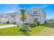 Attractive two-story home with manicured lawn, featuring well-maintained landscaping and welcoming curb appeal at 1562 Delightful Dr, Davenport, FL 33896