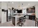 Beautiful kitchen features dark cabinetry, stainless steel appliances, and center island with seating at 1562 Delightful Dr, Davenport, FL 33896