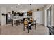 Open concept kitchen with stainless appliances, eat-in island, and a dining area with pendant lighting at 1562 Delightful Dr, Davenport, FL 33896
