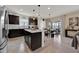Bright kitchen features stainless steel appliances, center island, and views into the adjacent dining area at 1562 Delightful Dr, Davenport, FL 33896