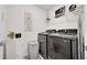 Laundry room with front loading gray washer and dryer, and decorations at 1562 Delightful Dr, Davenport, FL 33896