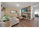Stylish living room features wood-look floors, decorative fireplace, and comfortable seating at 1562 Delightful Dr, Davenport, FL 33896