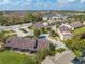 Aerial view of an expansive community with mature trees, well-maintained landscaping, and winding roads, showcasing its appeal at 8708 Papaya Dr, Kissimmee, FL 34747