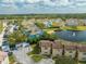 Aerial view of a colorful community with a lake and fountain, offering a vibrant and scenic living environment at 8708 Papaya Dr, Kissimmee, FL 34747