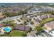 Expansive aerial view of a large community featuring a pool, lake, and lush landscaping, offering a serene living environment at 8708 Papaya Dr, Kissimmee, FL 34747