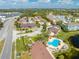 Scenic aerial view of community with pool, spa, and lush landscaping near a tranquil pond at 8708 Papaya Dr, Kissimmee, FL 34747